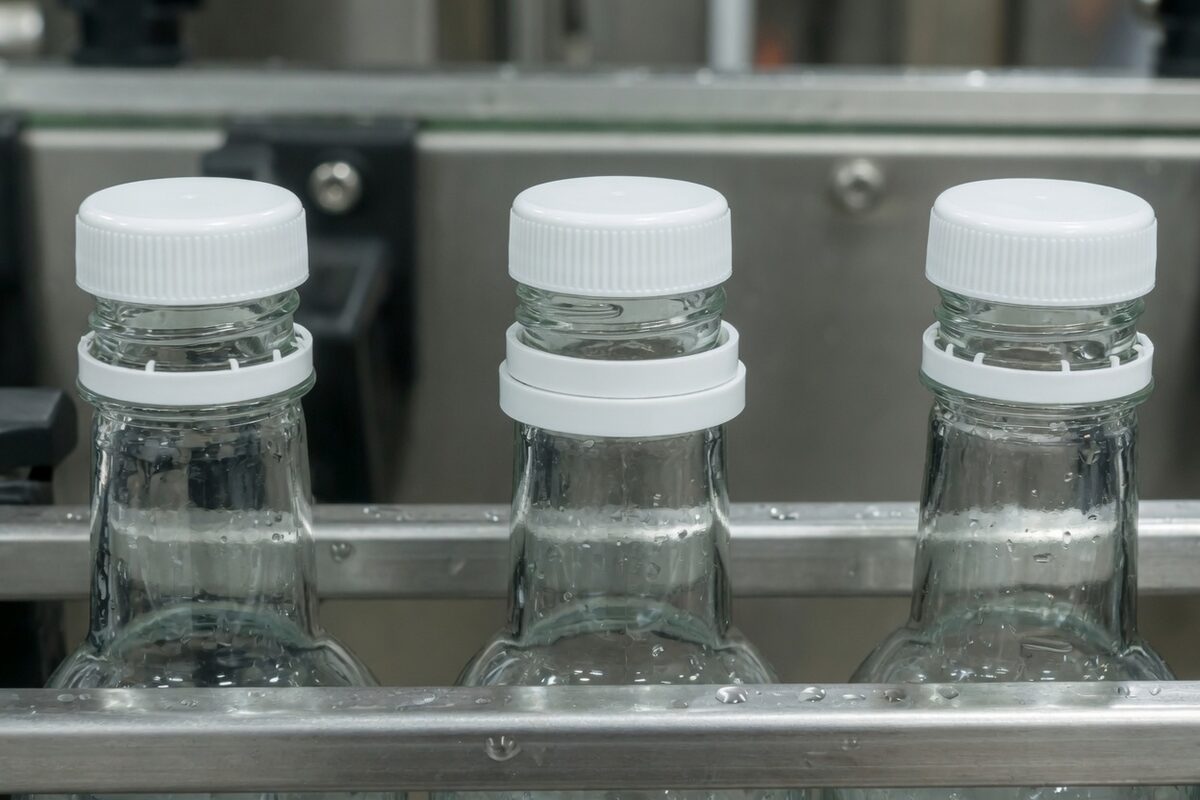 A bottle with the cap seated and the tamper band in one piece