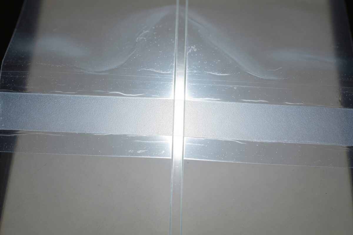 A clear medical pouch with a fold crossing the seal and leaving an open path through it