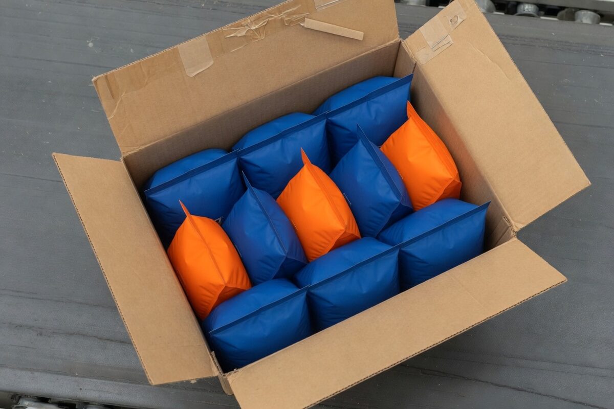 An open case packed mostly with blue pouches and three orange pouches mixed in