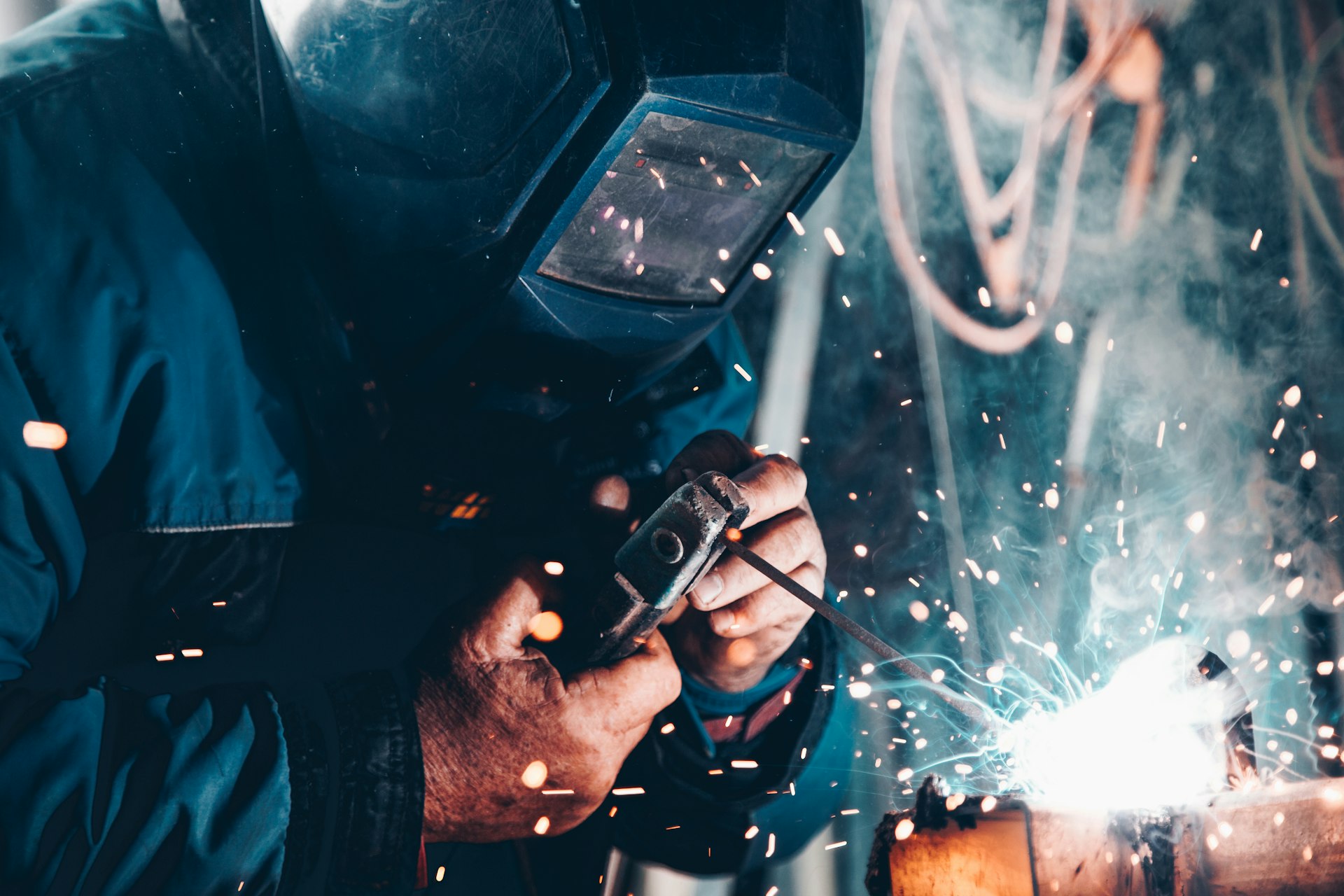 Welder fabricating steel for a commissioned industrial automation system
